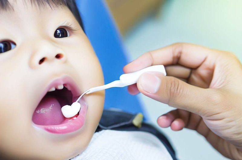 cleaning the First Tooth of kids boy